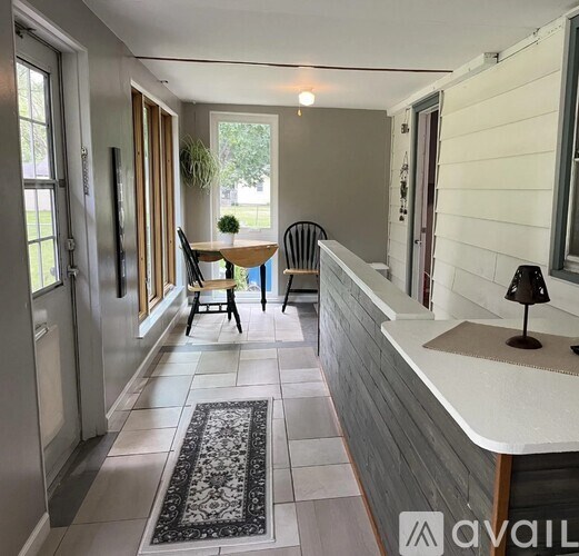 A dining room with a table and chairs.