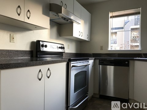 A modern kitchen with a stainless steel dishwasher and oven.