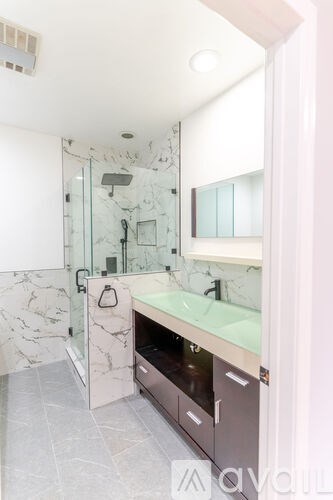 A marble bathroom with a walk in shower.