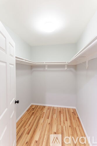 A room with wooden floors and white walls.