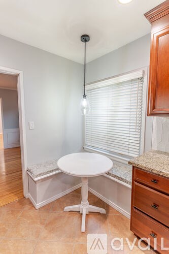 A small kitchen with a table and a bench.