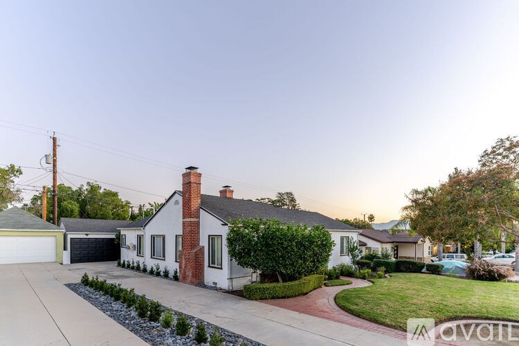 A house with a red brick chimney is for sale.