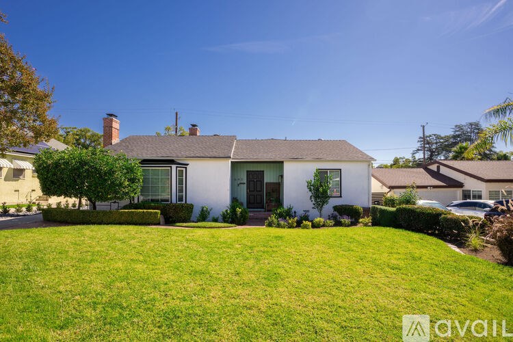A house with a well-kept lawn in front.