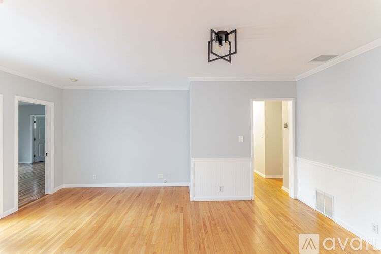 A room with wooden floors and white walls.