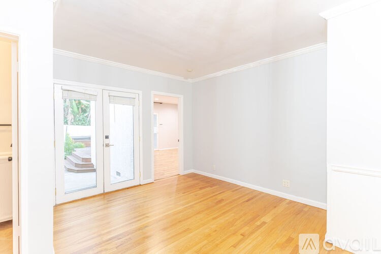 A room with wooden floors and white walls.