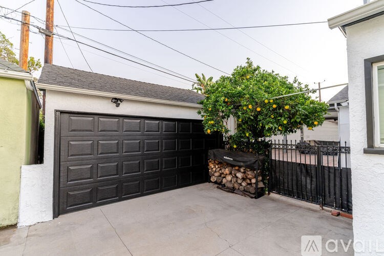 A garage with a tree in front of it.