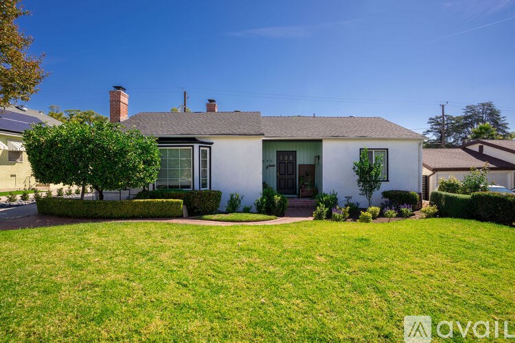 A house with a green lawn in front.