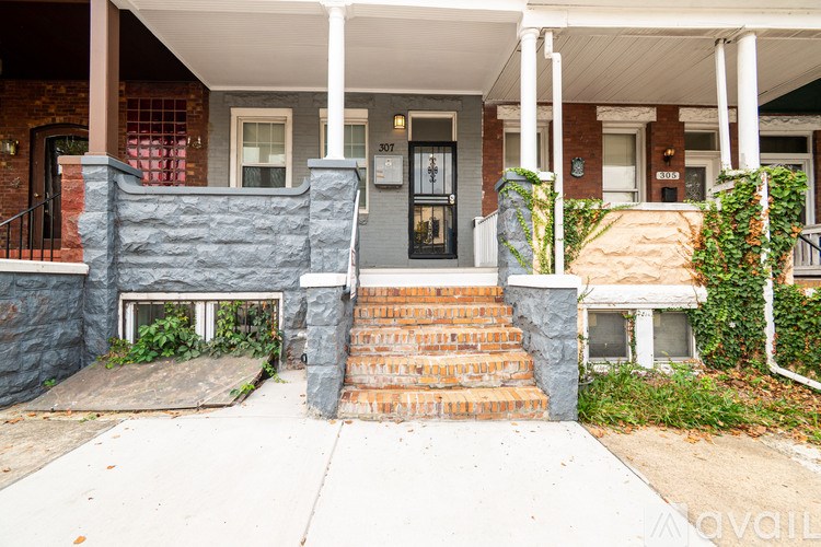 A house with a front porch and a black door.