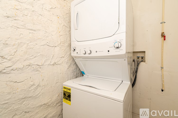 A white dryer is installed in a wall.