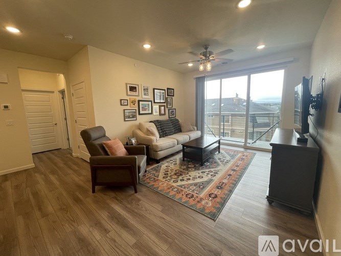 A living room with a couch, chair, and rug.