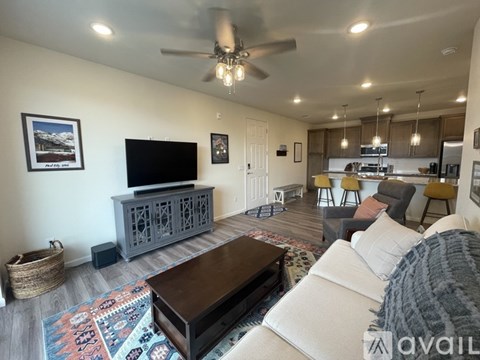 A living room with a white couch and a wooden coffee table.