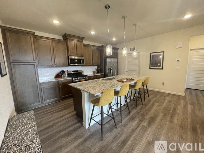 A kitchen with a table and chairs in the middle of the room.
