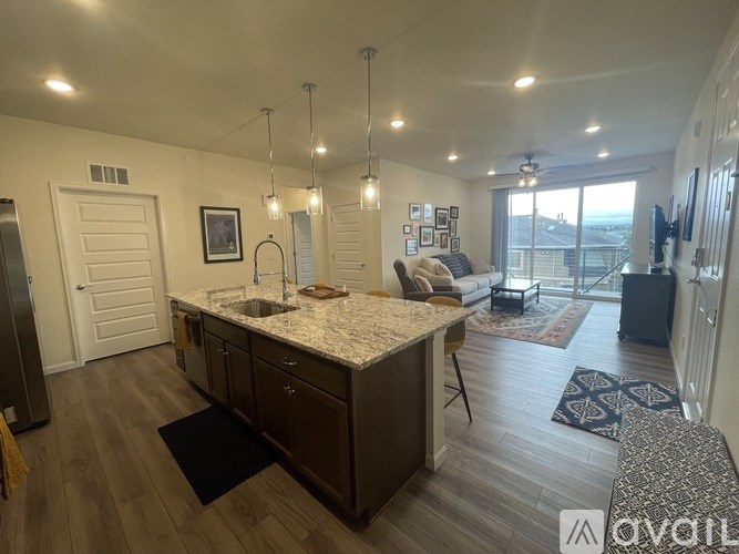 A kitchen with a granite countertop and a sink.