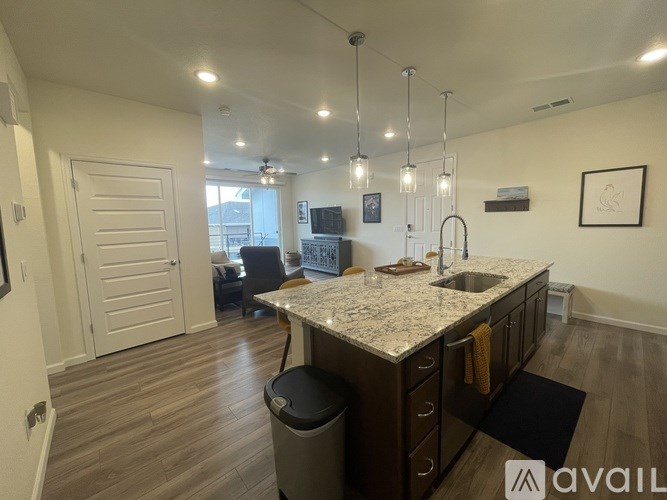 A kitchen with a granite countertop and a sink.