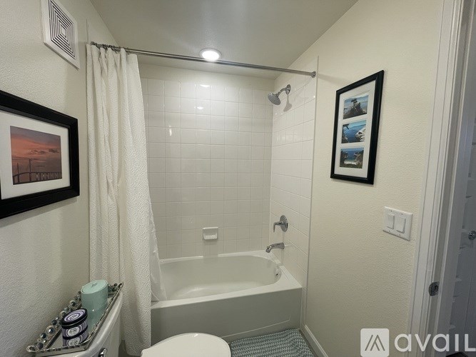 A bathroom with a white tub and a white toilet.