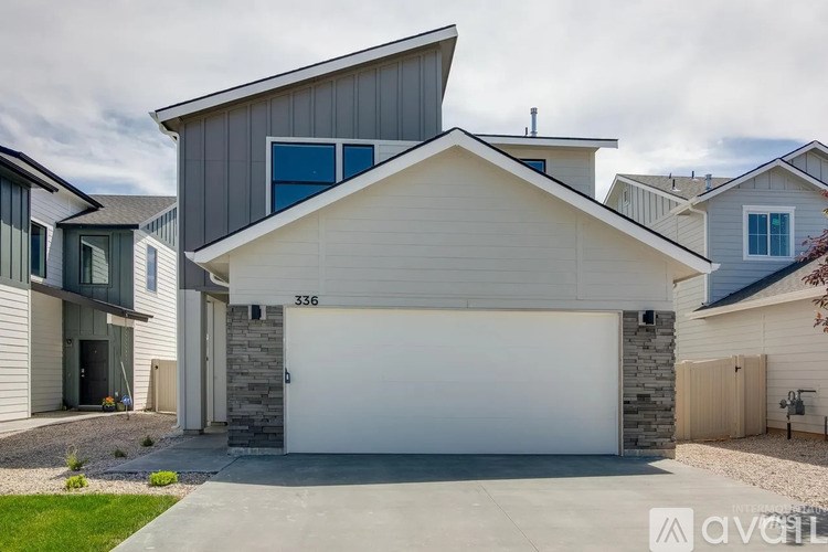 A modern house with a garage is numbered 336.