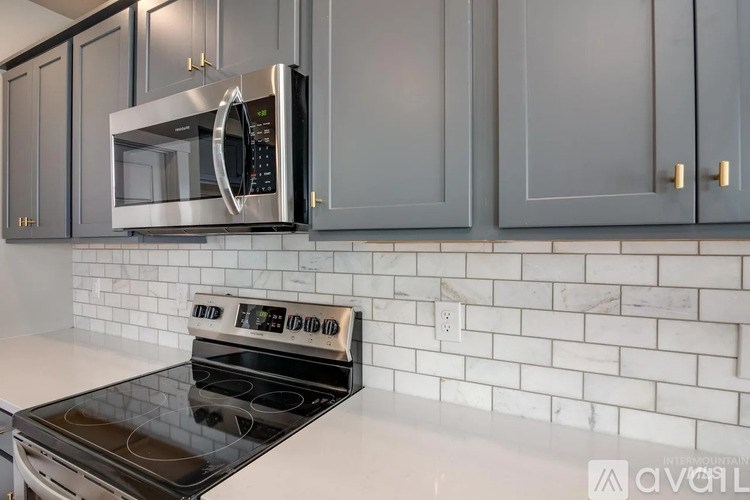 A kitchen with a stove and a microwave above it.
