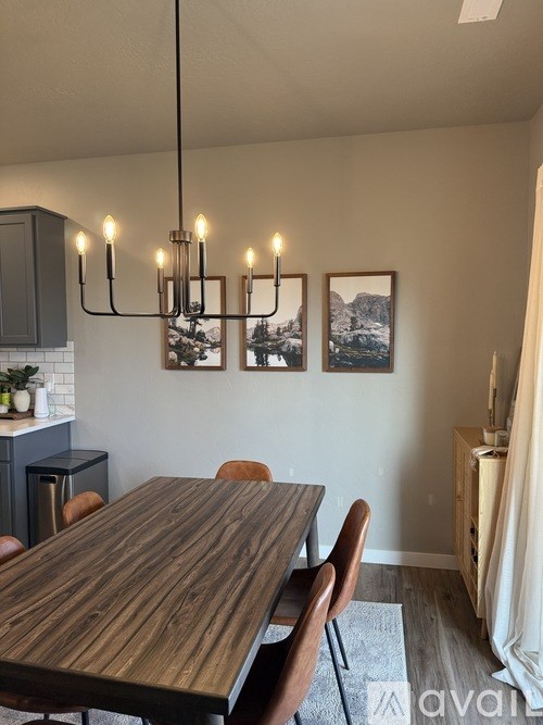 A dining room with a wooden table and chairs.