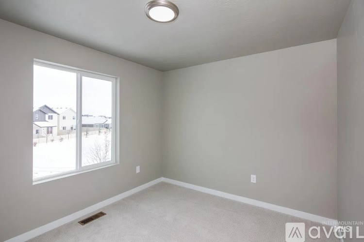 A room with a window and a ceiling light.