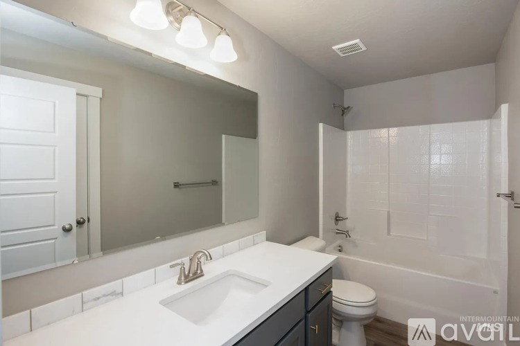 A bathroom with a white sink and a white toilet.