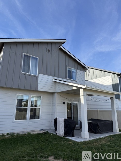 A house with a covered patio and a white door.
