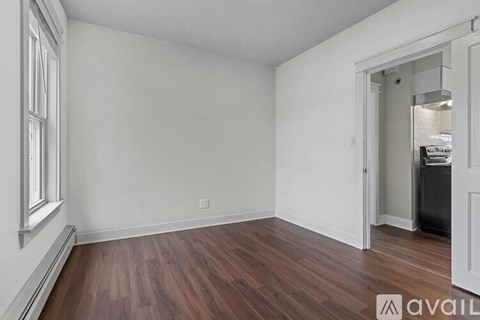 A room with wooden floors and white walls.