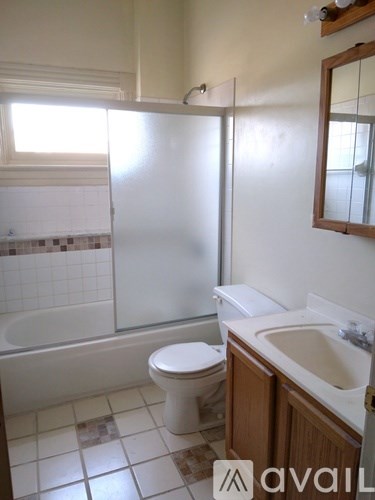 A bathroom with a toilet, sink and bathtub.