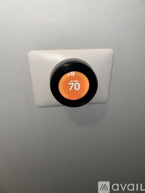 A thermostat showing 70 degrees on a white background.