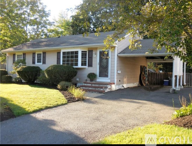 A house with a front yard and a driveway.