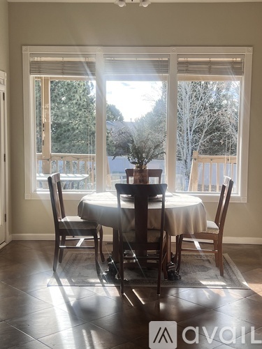 A dining room with a table set for four.