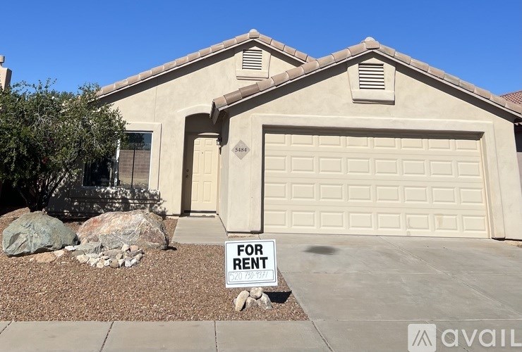 A house with a garage door is for rent.