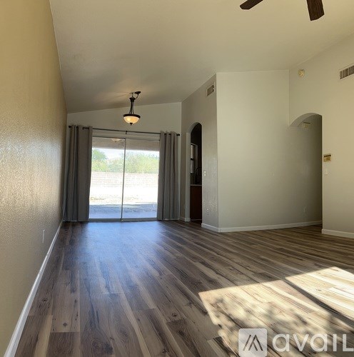 A room with a wooden floor and a chandelier.