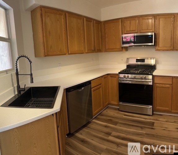 A room with wooden flooring and a round mirror on the floor.