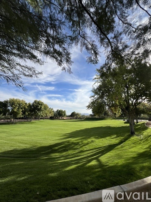 A room with a ceiling fan and a window with curtains.