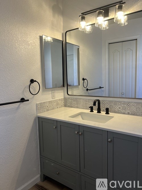 A bathroom with a sink and a cabinet.