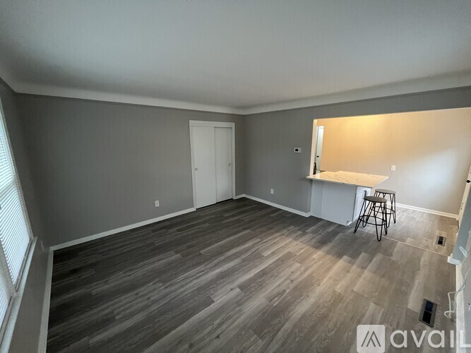 A room with a grey floor and a white door.