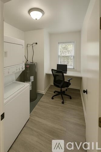 A small room with a desk and a chair.