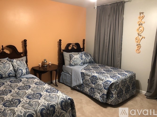 Two twin beds with blue and white bedspreads in a room.