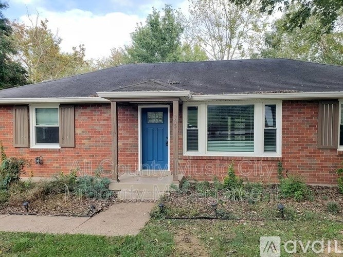 A red brick house with a blue door and a sign that says "available".