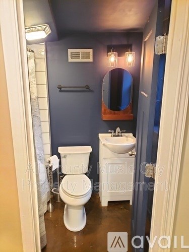 A white toilet and sink in a small bathroom.