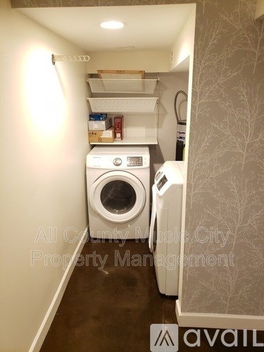A small laundry room with a washer and dryer.