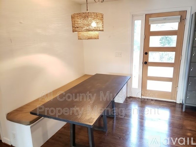 A room with a wooden table and a door.