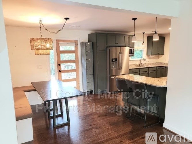 A kitchen with a table and chairs in the middle of the room.