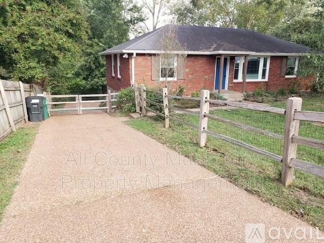 A house with a blue door and a wooden fence.
