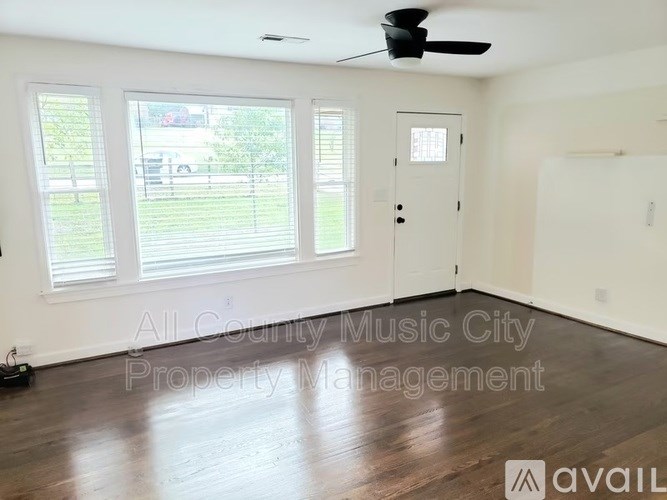 A room with a ceiling fan and a door is available for rent.