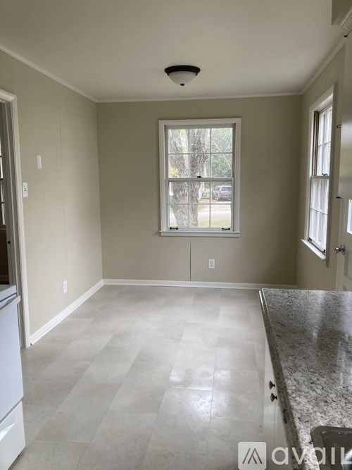 A kitchen with a marble countertop and a window.