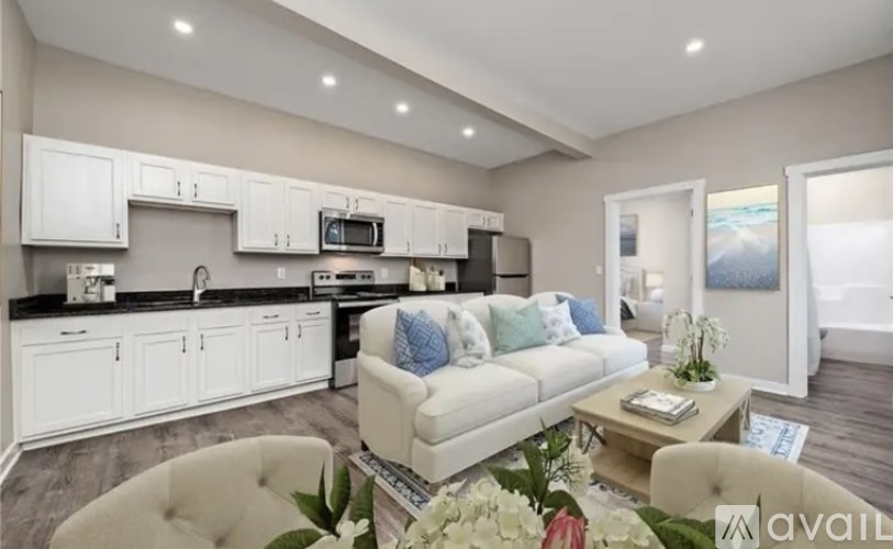 A modern kitchen with white cabinets and a large island.