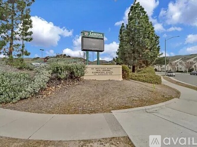 A sign in front of a tree reads "AVAILABLE".