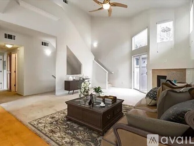 A living room with a brown coffee table and a couch.
