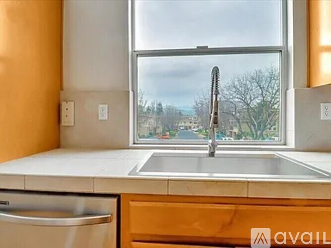 A kitchen with a window overlooking a street.